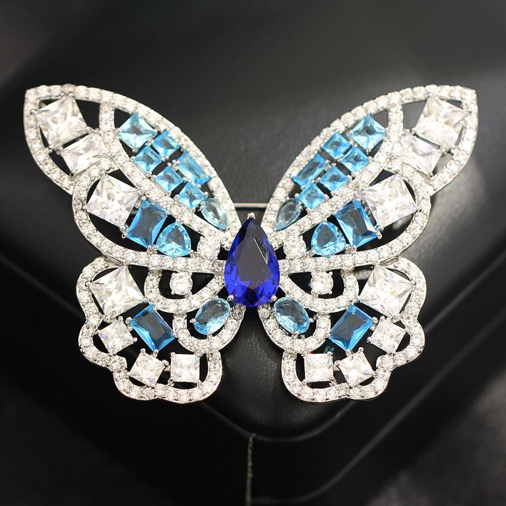 

Light luxury, high-end, exaggerated luxury, blue yellow butterfly brooch, heavy industry, full of zircon insect pins, anti-light women