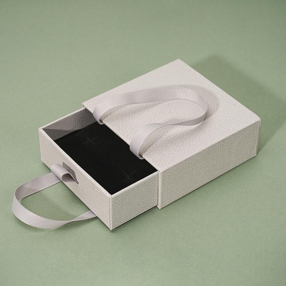 Compact Portable Jewelry Box for Rings, Necklaces, and Ear Studs - Simple Design, Ready for Gift-Giving.