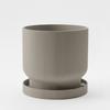 A Modern, Light Gray Flowerpot with a Drip Tray, Simple and Functional.