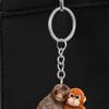 Klíčenka s přívěskem Plácni opici Oboustranný akrylový opičák držící hračku Klíčenka Batoh Kabelka Doplňky