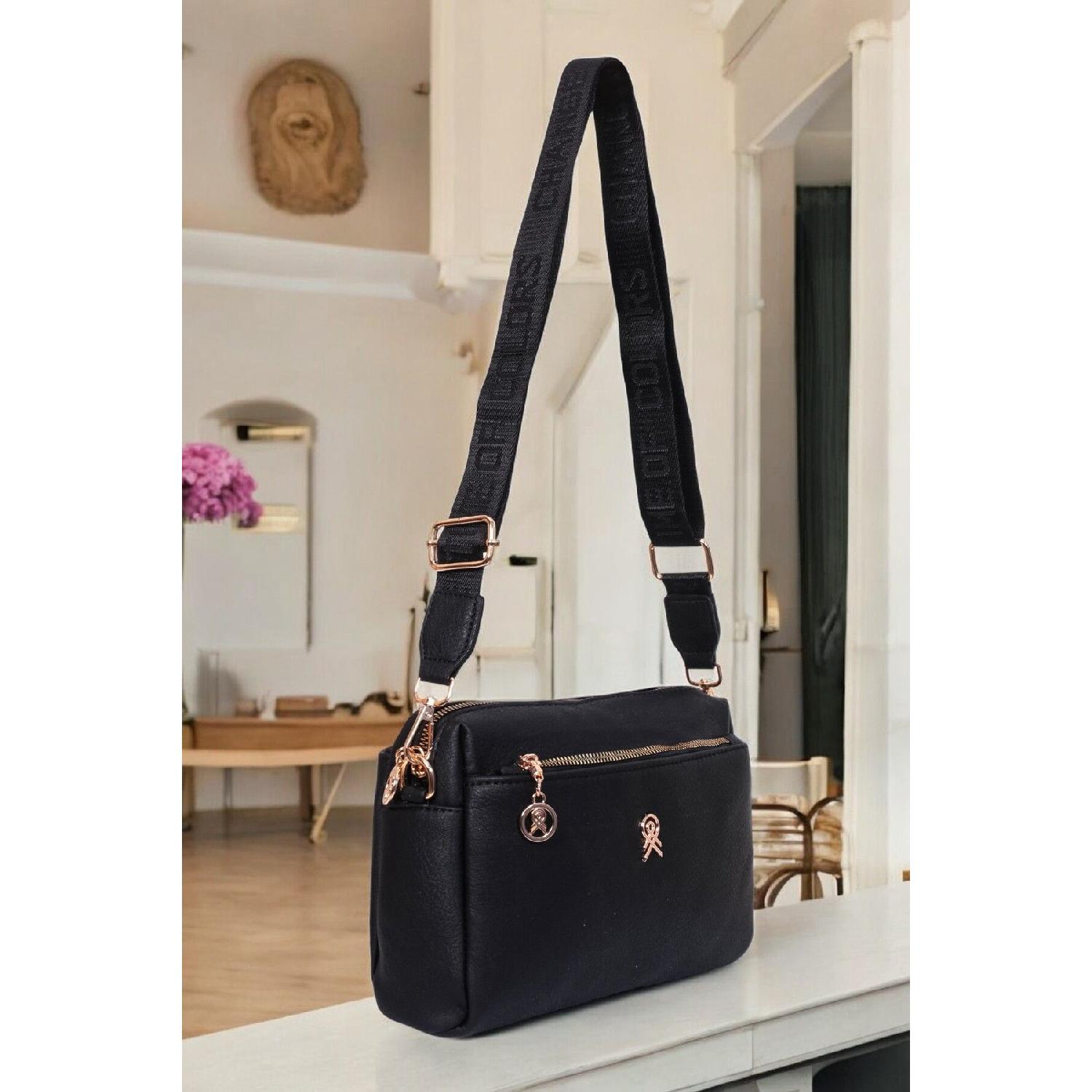 

Жіноча чорна сумка через плече з трьома відділеннями на підкладці та регульованим ременем на стовпці чорний