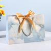 In-Stock White Cardboard Gift Bags with Bow Handle, Customizable Logo for Clothing Stores