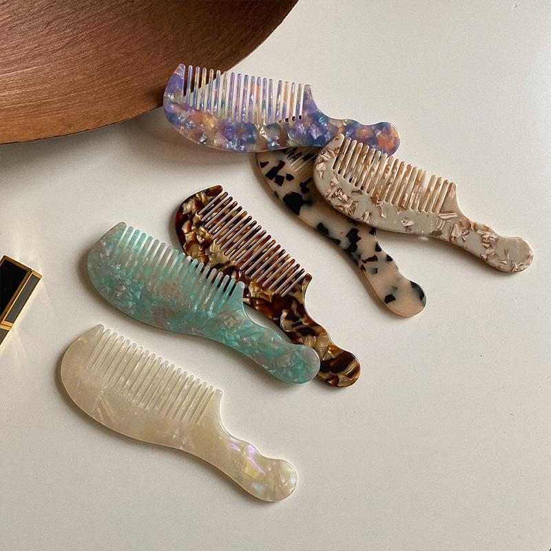 Elegant and compact tortoise shell acetate hair comb for easy portability.