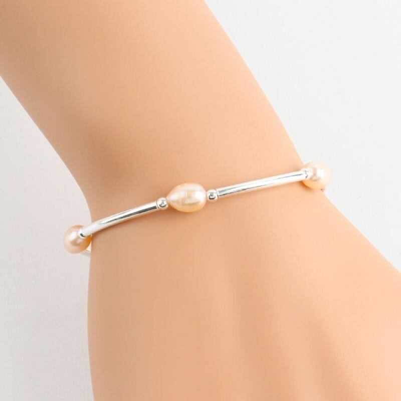 

Pearl bracelet, simple, clingy, subtle guest look, silver ball orange