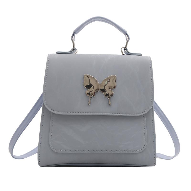 Design Solid Color New Fashion Casual Butterfly Hardware College Wind Backpack Shoulder Backpack Women