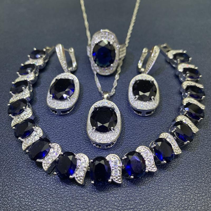 Čtyřdílná sada vykládaná světle modrým zirkonem Dámské náušnice náramek prsten Módní párty svatba