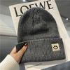 Cute smiley face label wool hat women's autumn and winter warm trend versatile ear protector black knitted hat men