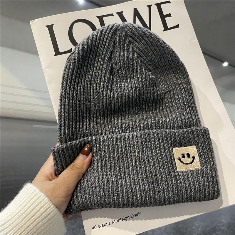 Cute smiley face label wool hat women's autumn and winter warm trend versatile ear protector black knitted hat men