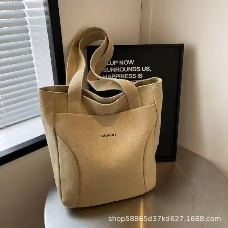 

Canvas bag women s large-capacity 2026 new work portable shoulder college student class cloth bag commuter tote bag хакі