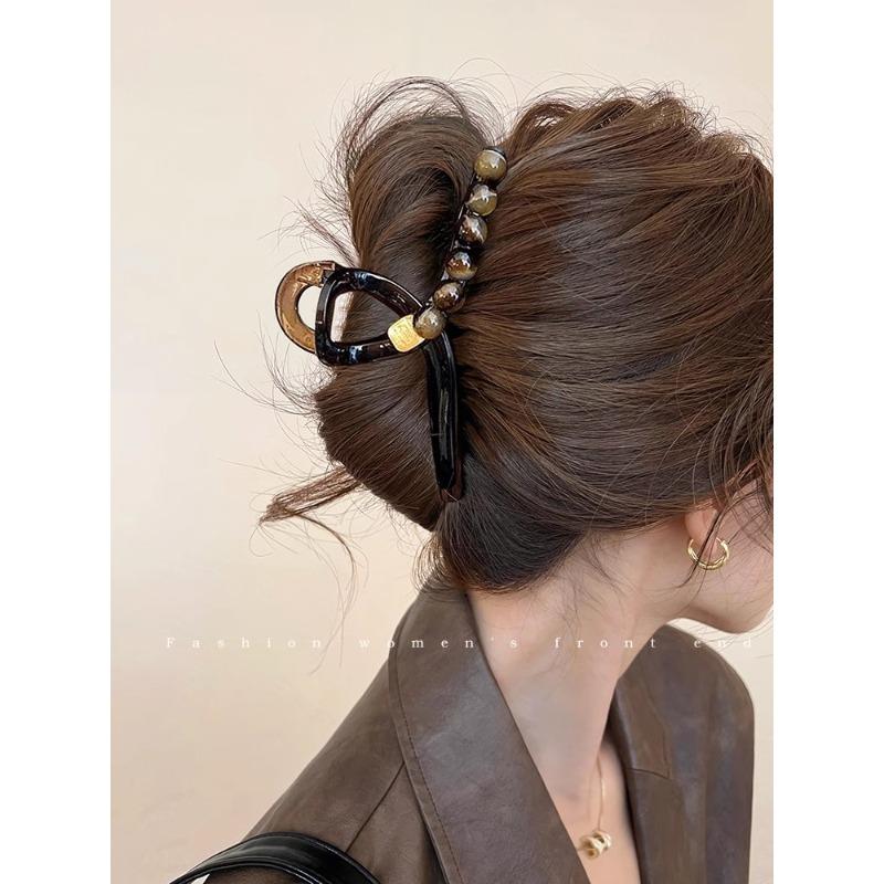 A Gradient Round Bead Shark Clip A Large Hair Clip and A Hairpin for The Back of A Woman's Head