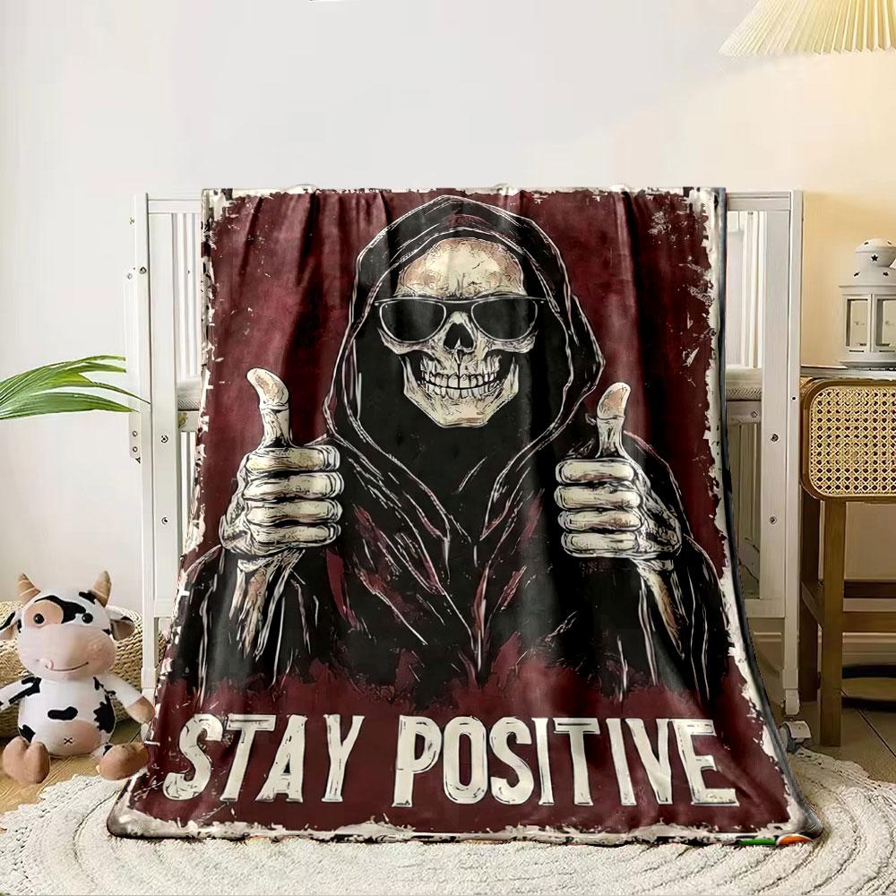 A hooded figure with skeletal hands giving thumbs up on a red background. for all seasons blanket lunch break throw gift 80cm x 120cm