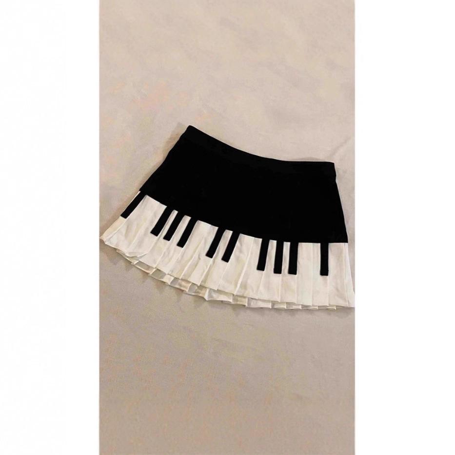 Completo retrò bianco e nero design pianoforte artistico gonna corta primavera estate autunno nuova gonna a pieghe piccole