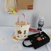 Damenhandtasche aus Canvas mit Nischendesign und Aufdruck, zum Mitnehmen von Lunchboxen, Bento-Stoffbeutel, einfache, vielseitige Einkaufstasche im literarischen Eimer-Stil