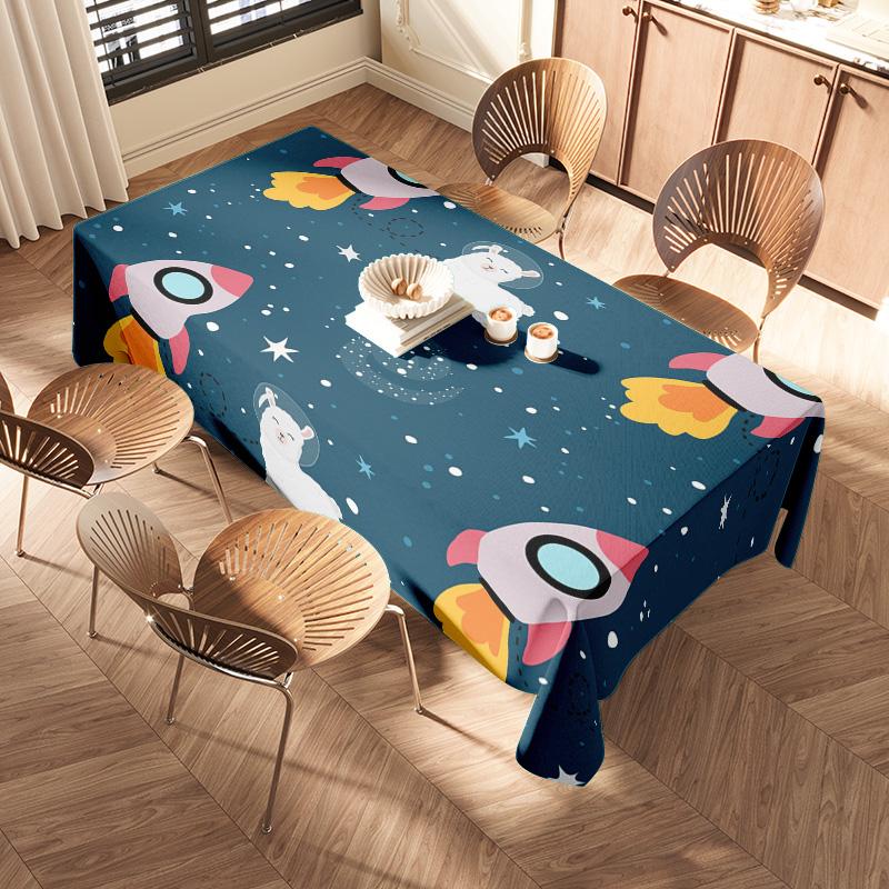 Space-themed tablecloth with rocket and polar bear design suitable for kids’ parties or home decor!