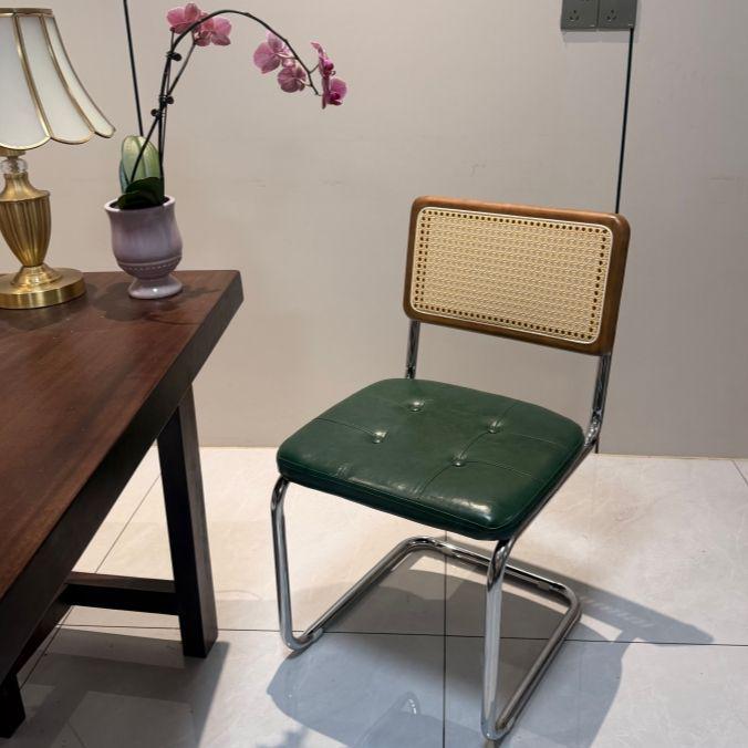 Elegantly crafted armless rattan dining chair in retro pastoral style, perfect for cafes, guesthouses, and vintage settings.