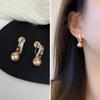 French Retro Pearl Clip-On Earrings: Mosquito Coil Design, Hong Kong Niche Style, No Piercing Needed, Women's High-End Fashion Accessories.