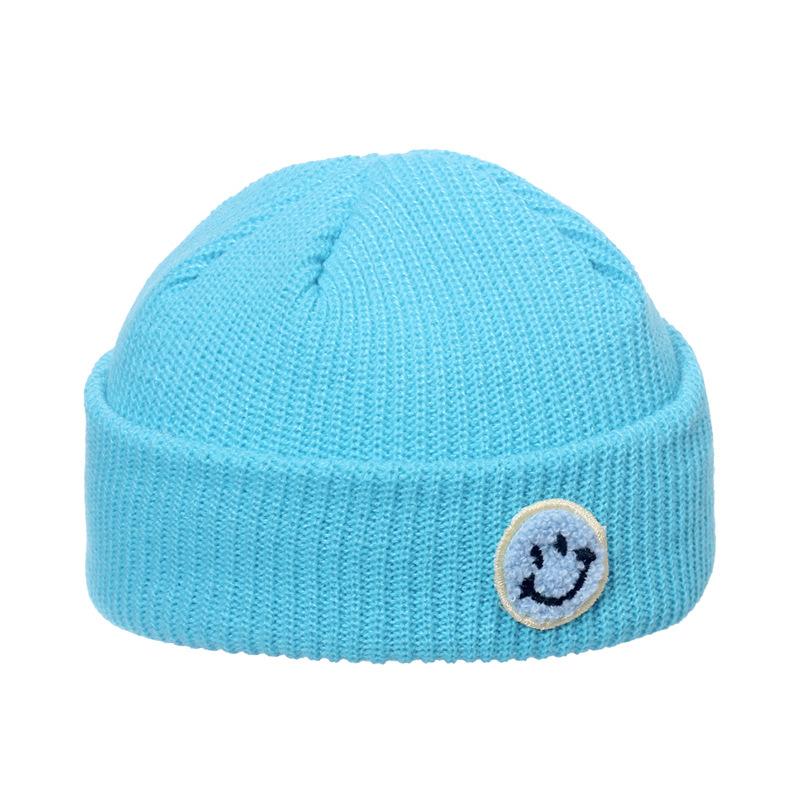 Autumn and winter wool hat male trend Japanese and Korean yuppie knitted warm smiley face sticker landlord hat candy color melon fur hat female