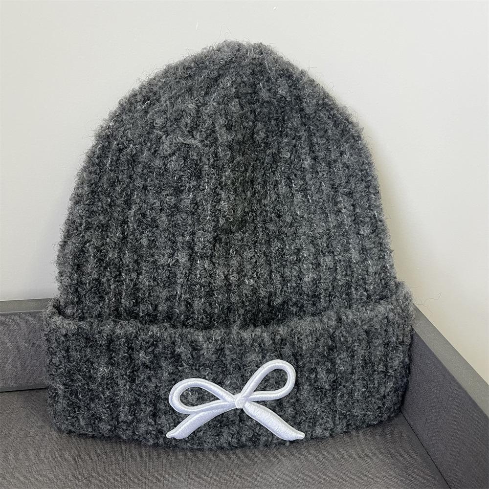 Hat women's autumn and winter wool hat new cute bow versatile cold hat ear protection warm knitted hat tide