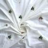 Light Apricot Cotton Fabric with Small Embroidered Flowers - Fresh Style for Women's Clothing and Children's Bags.