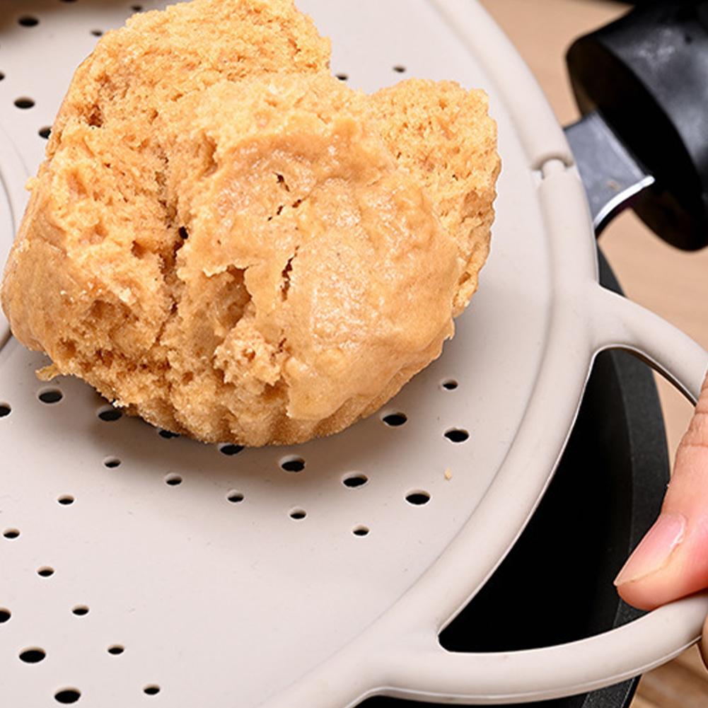 Easily Storeable Silicone Pot Holder That Doubles As a Spill Stopper Tool