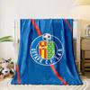 A blue background with red diagonal lines and a football club crest. for all seasons blanket lunch break throw gift
