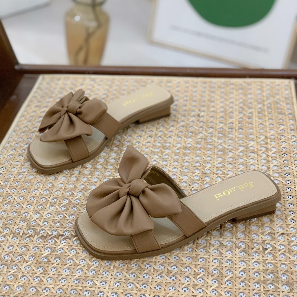 Stepping on shit slippers women wear 2025 new summer Internet celebrity fairy wind bow wedge soft bottom one-word