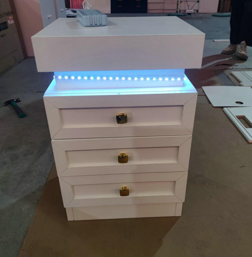 Bedside table, three drawers, with charging station, 2 AC power outlets/2 USB ports, European standard plug, white.