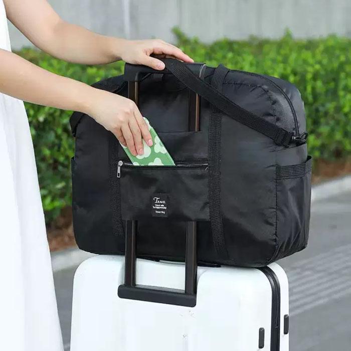Compact travel bag: suitcase-compatible, hand-held, features an external pocket, handle slip-over design, with matching accessory bag.
