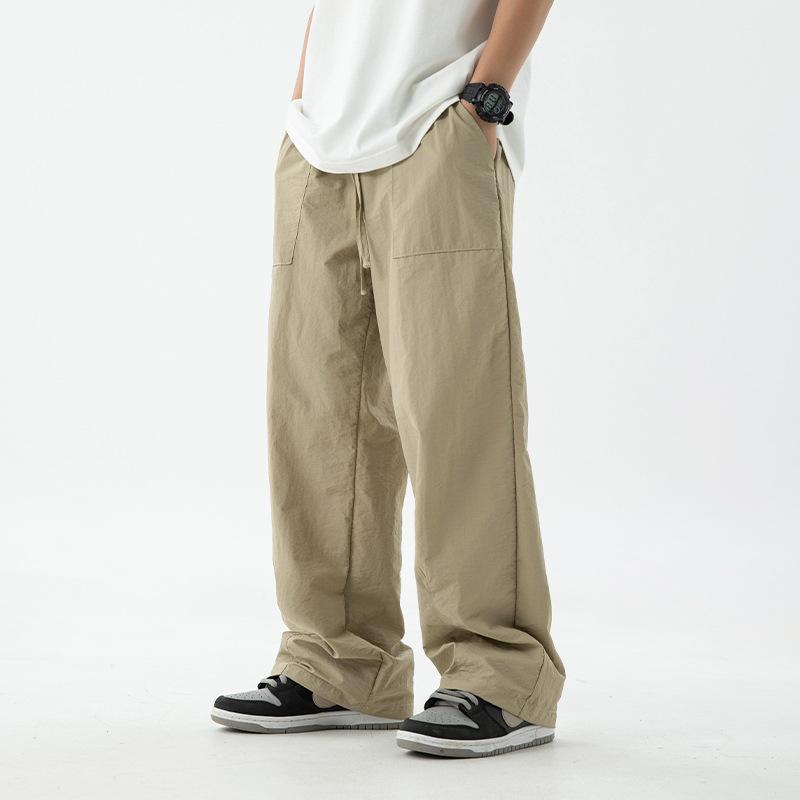 Męskie spodnie wiosenno-jesienne o lekko szerokiej prostej nogawce, jednolite, luźne, casualowe spodnie robocze ze sznurkiem, sportowe długie spodnie