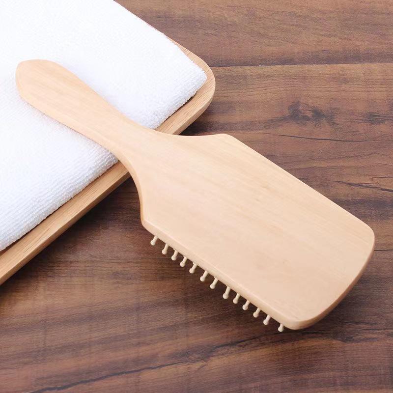Spazzola a pagaia in legno antistatica per la cura dei capelli lunghi e il massaggio, riduce la caduta dei capelli e doma i ricci con design a cuscino.