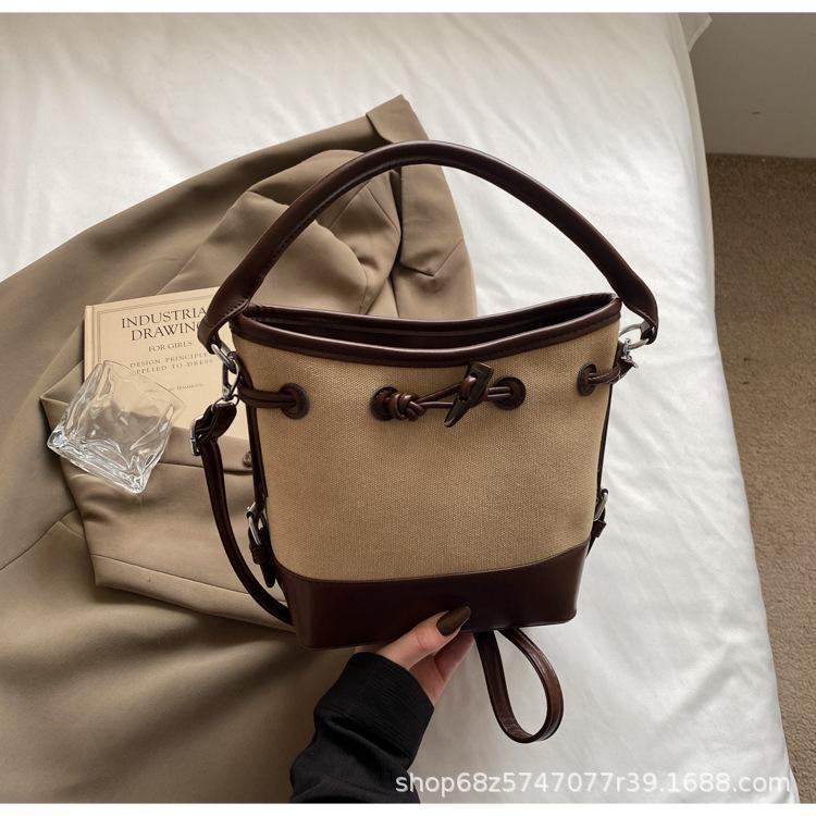 

2025 new niche design canvas portable bucket bag women s simple high-end commuter shoulder messenger women s bag