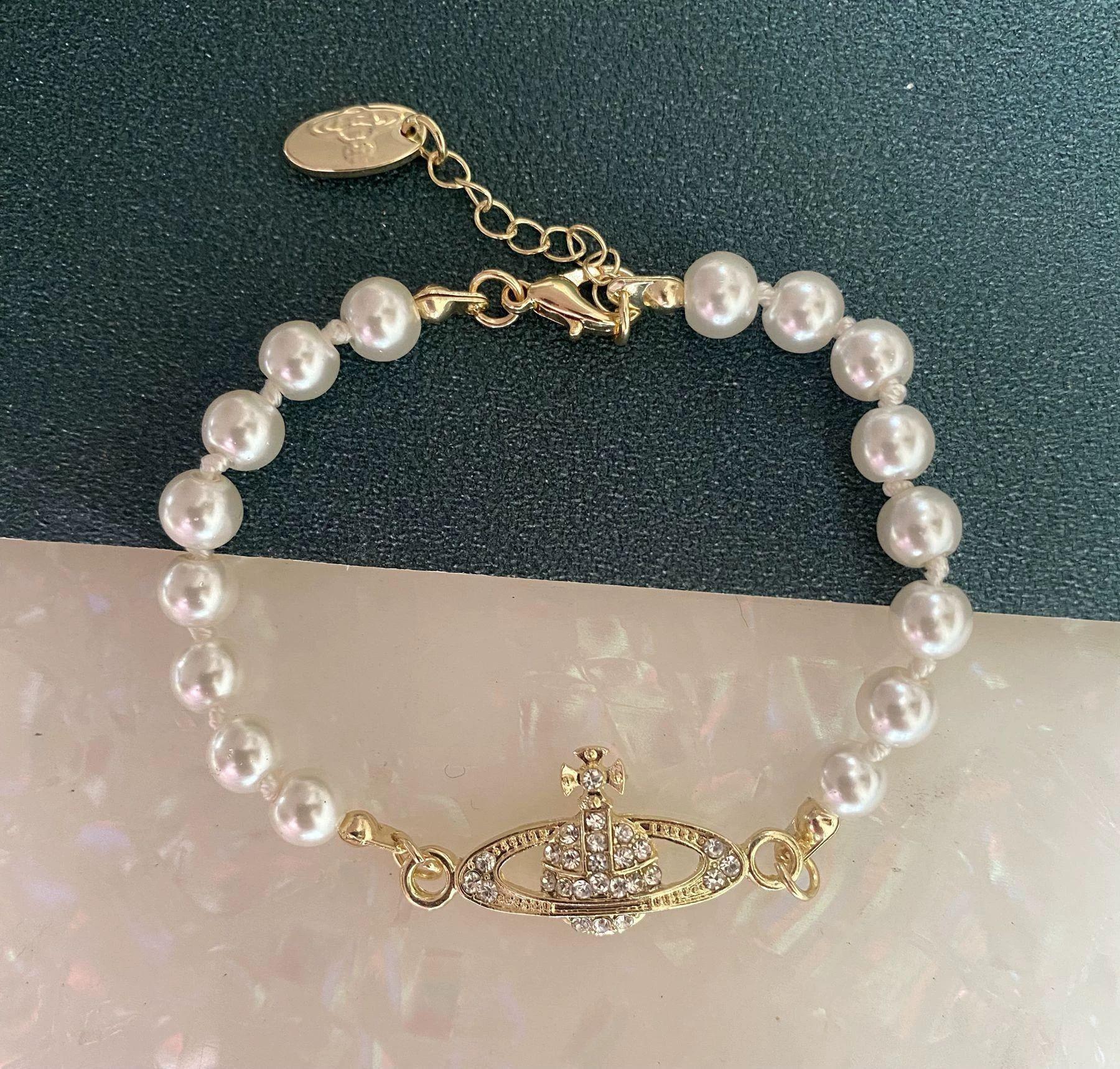 

Empress Dowager Saturn Pearl Bracelet with Diamond Planet Pendant - Elegant, Unique, and Trending Jewelry.