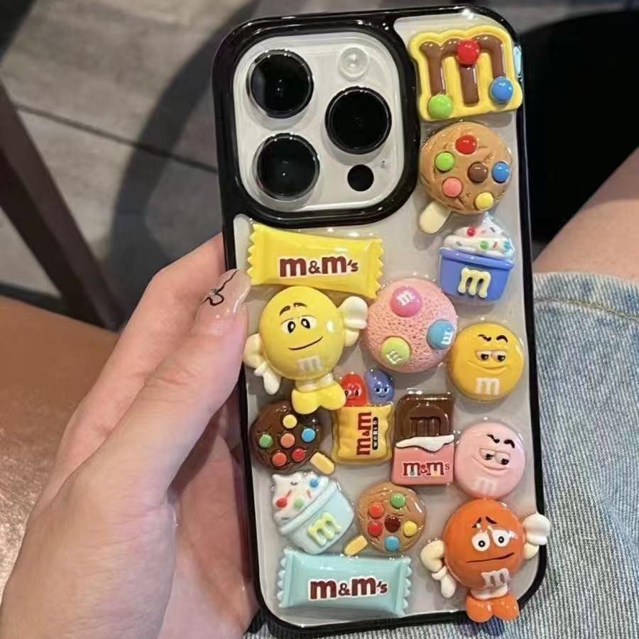 

Apple iPhone 17 3D Cartoon M&M s Cookie and Ice Cream Case 16 Plus