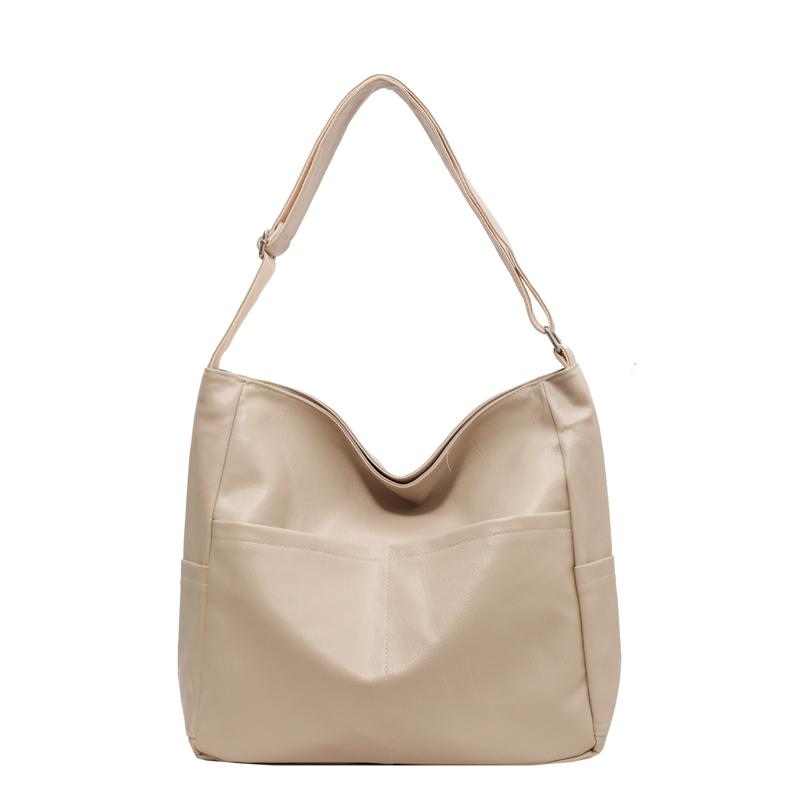 

Чорна сумка через плече з поліуретану великої місткості. Велика сумка бежевий