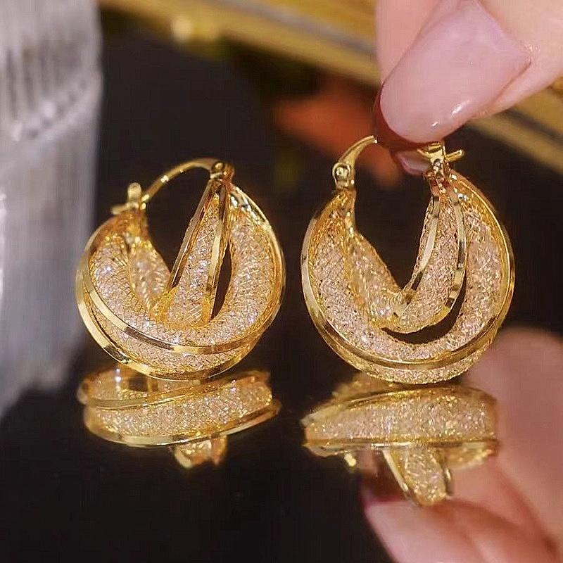 

Niche design cross-twisting unique circle earrings women s light luxury high-end geometric earrings European and American temperament ear buckles