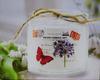 Portable glass candle holder with a butterfly for interior and patio decoration