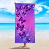A women's oversized beach towel that is soft quick-drying and super absorbent with a beautiful butterfly and flower design