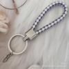 Gevlochten Lederen Touw Sleutelhanger met Poppenhanger - Modieus en Creatief Accessoire