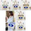 Umweltfreundliche Stroh-Schultertasche mit blauem Augen-Stickdesign für Sommerausflüge