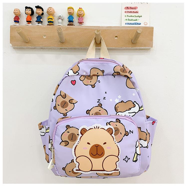

Школьный рюкзак 2025 новый детский для мальчиков и девочек с мультяшным рисунком, рюкзак с рисунком капибары Small фиолетовый