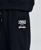 Daenkkomma Crayon Shin-Chan 1992 Face Embroidery Sweatpants (Black, Cream)