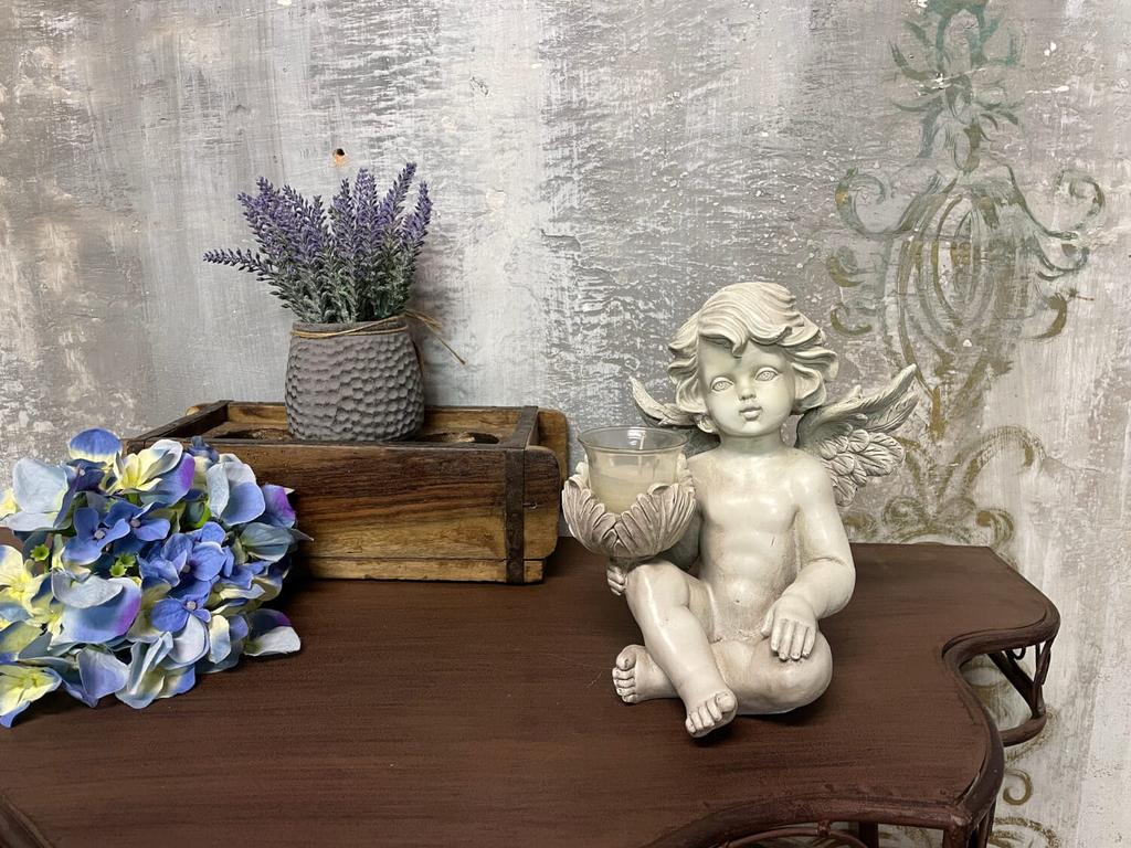 White angel sculpture with a candle
