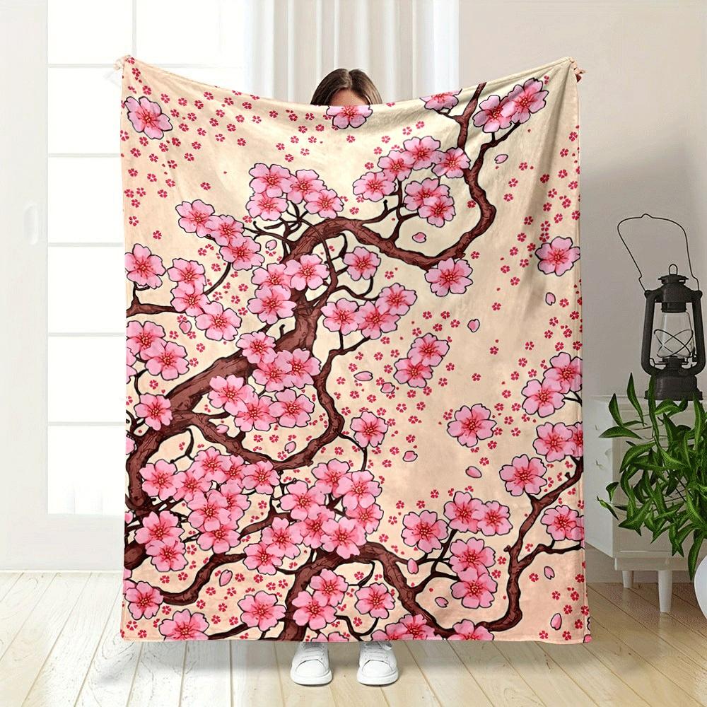 Pink cherry blossoms with brown branches and scattered petals on beige. for all seasons blanket lunch break throw gift