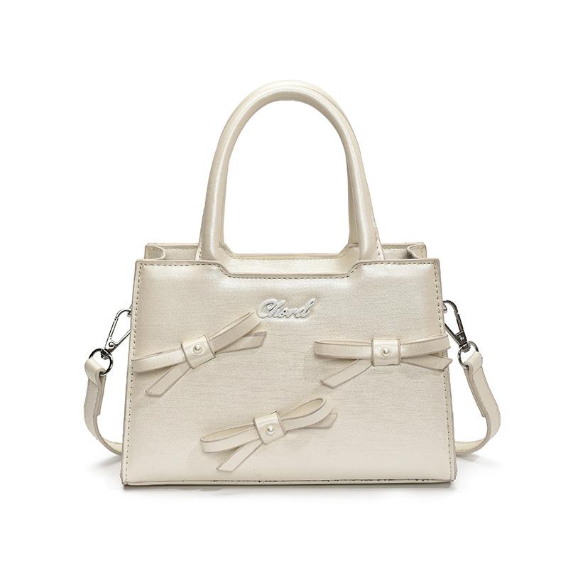 Korean version of bow small square bag women's 2025 summer new simple and fashionable handheld women's bag women's shoulder oblique span bag