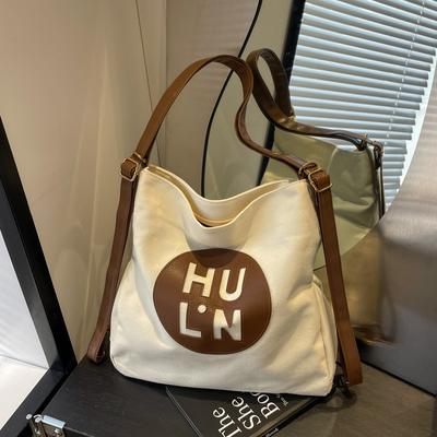 Plátěná taška dámská 2025 nová módní velkokapacitní víceúčelový batoh studentská třída ramenní nákupní taška