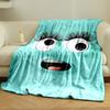 A playful turquoise face with large eyes, long lashes, and an open mouth. for all seasons blanket lunch break throw gift