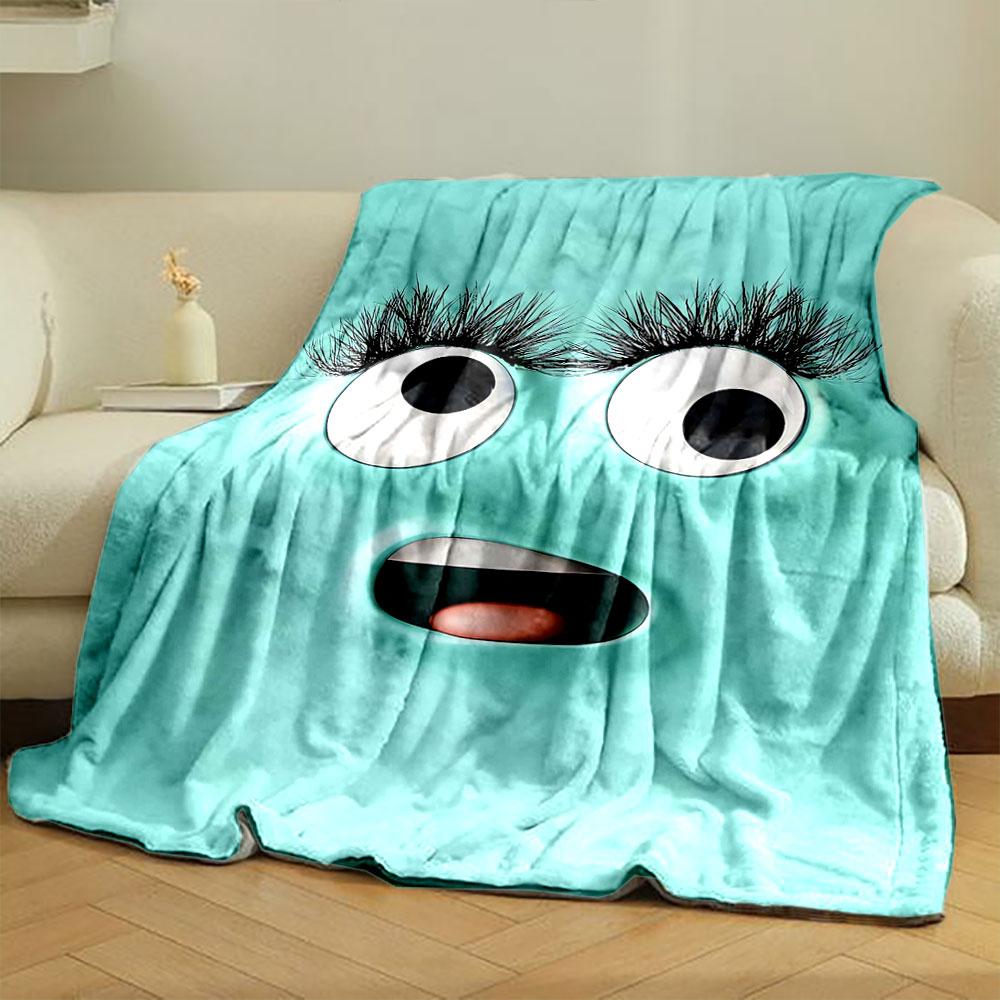 A playful turquoise face with large eyes, long lashes, and an open mouth. for all seasons blanket lunch break throw gift