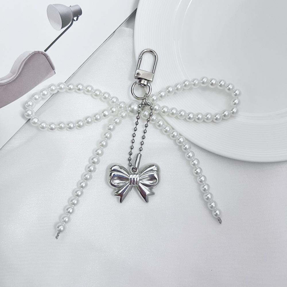 

Korean Sweet Girl Pearl Bow Heart Pendant Keychain Bluetooth Earphone Charm