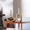 Goldene Keramikvase, Dekorationsobjekt, Hohlgeometrische Donut-Vase, Blumenarrangement für das Wohnzimmer, Heimdekoration