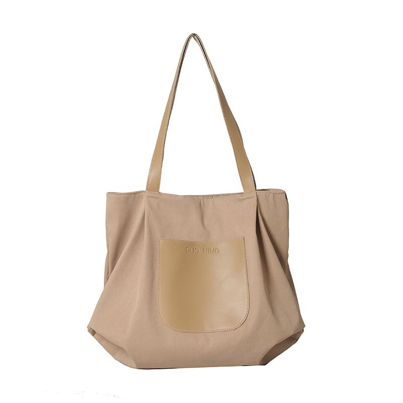 

Casual large-capacity bag women s 2025 new simple and versatile commuter shoulder canvas tote bag lightweight travel bag хакі